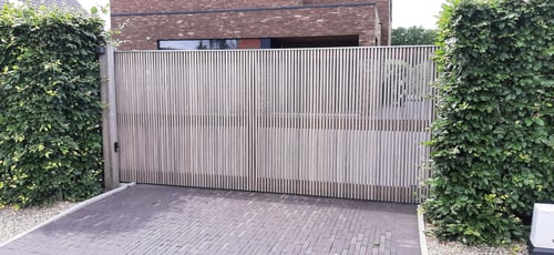 Padouk houten schuifpoort geplaatst door schrijnwerker Bongaerts D. in Ellikom